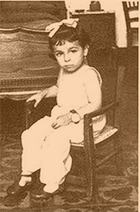 Four year old Nadina sitting in her little chair